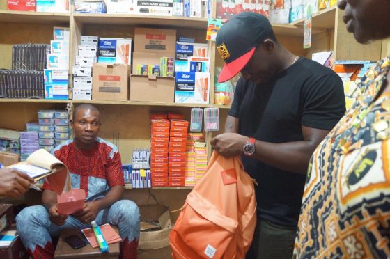 Lagoshats discussing stationary requirements with Store owner in Dosumu